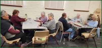 A group of people sitting at a table

AI-generated content may be incorrect.
